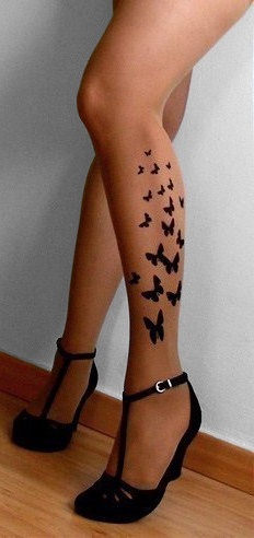 Black left leg butterfly tattoo on leg