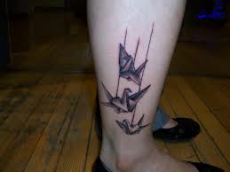Black line studio origami tattoo on leg