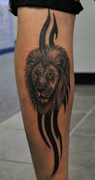 Black lines and lion tattoo on leg