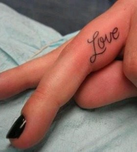 Black love quote tattoo on finger