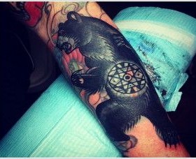Black lovely bear tattoo on arm