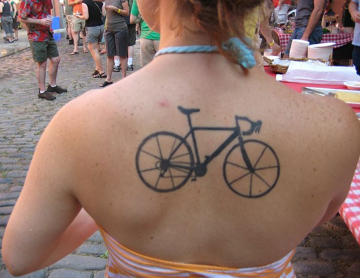 Black lovely bicycle tattoo on back
