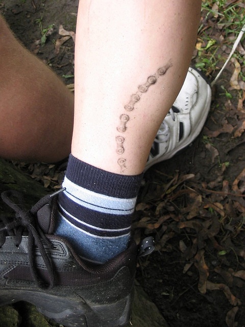 Black lovely bicycle tattoo on leg