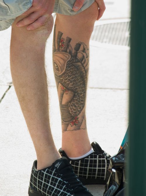 Black lovely fish tattoo on leg