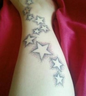 Black lovely star tattoo on arm