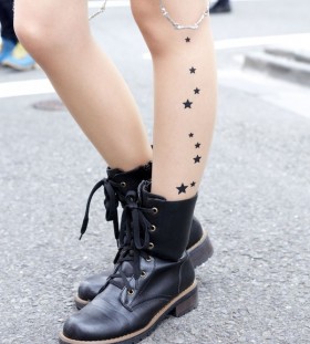 Black lovely star tattoo on leg