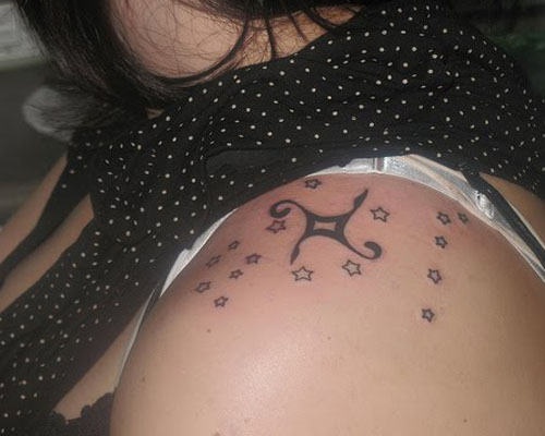 Black lovely star tattoo on shoulder