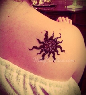 Black lovely sun tattoo on shoulder