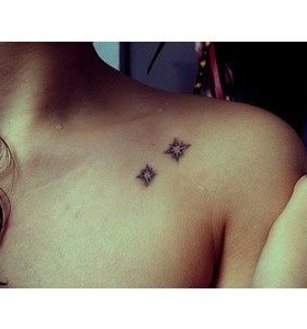 Black mini star tattoo on shoulder