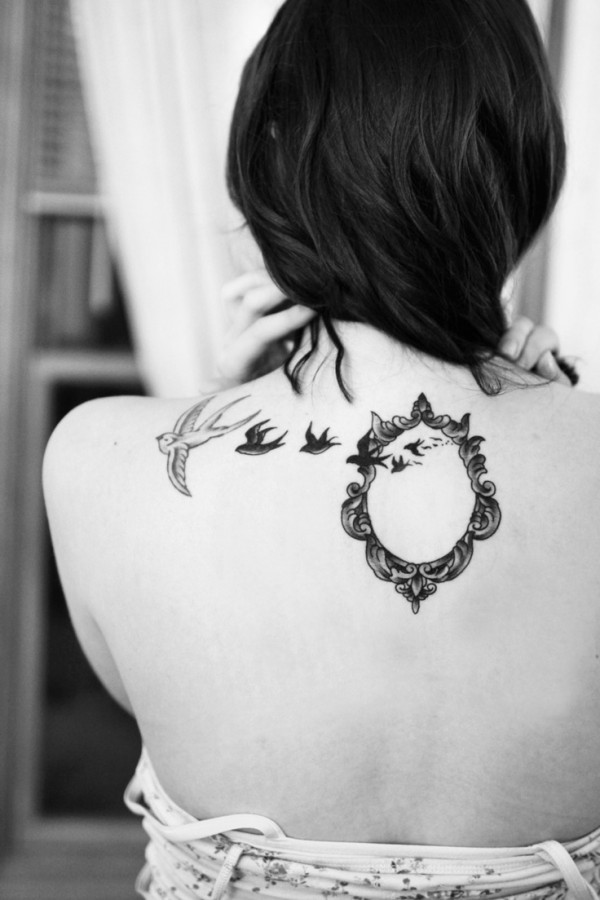 Black mirror and bird tattoo on shoulder