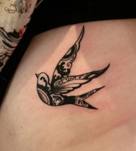 Black ornaments and bird tattoo