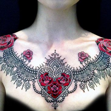 Black ornaments and red heart flower tattoo on chest
