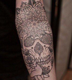 Black ornaments and rose skull tattoo on arm
