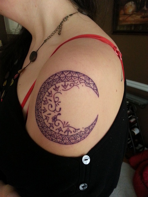Black ornaments moon tattoo on shoulder