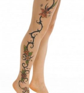 Black ornaments of flowers and tribal tattoo on leg