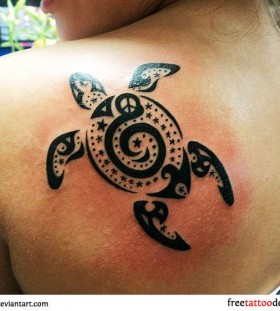 Black owal turtle tribal tattoo on shoulder