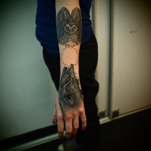 Black owl and amazing wolf tattoo on arm
