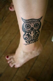 Black owl tribal tattoo on leg