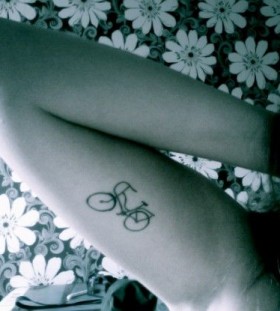 Black pretty bicycle tattoo on arm