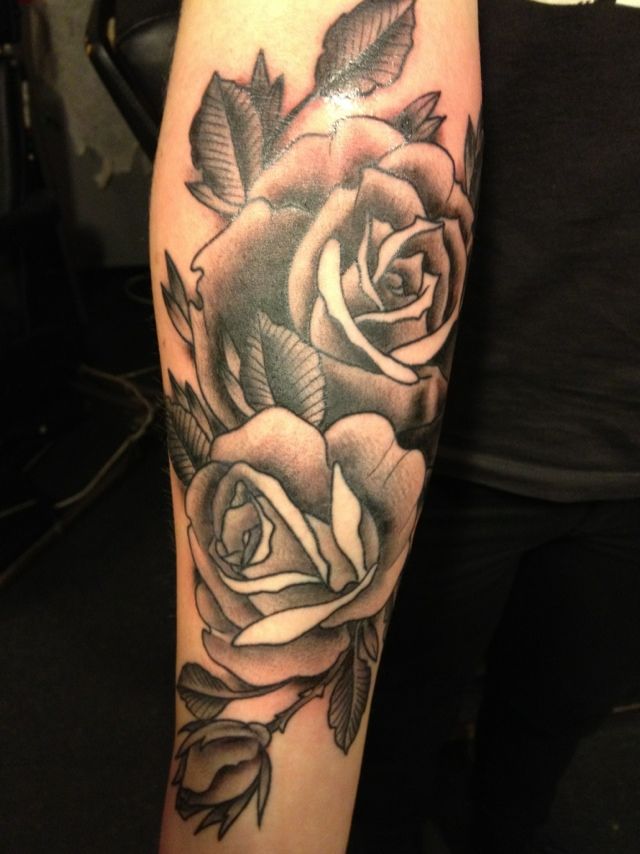 Black pretty rose tattoo on leg