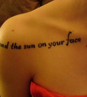 Black quote sun tattoo on shoulder