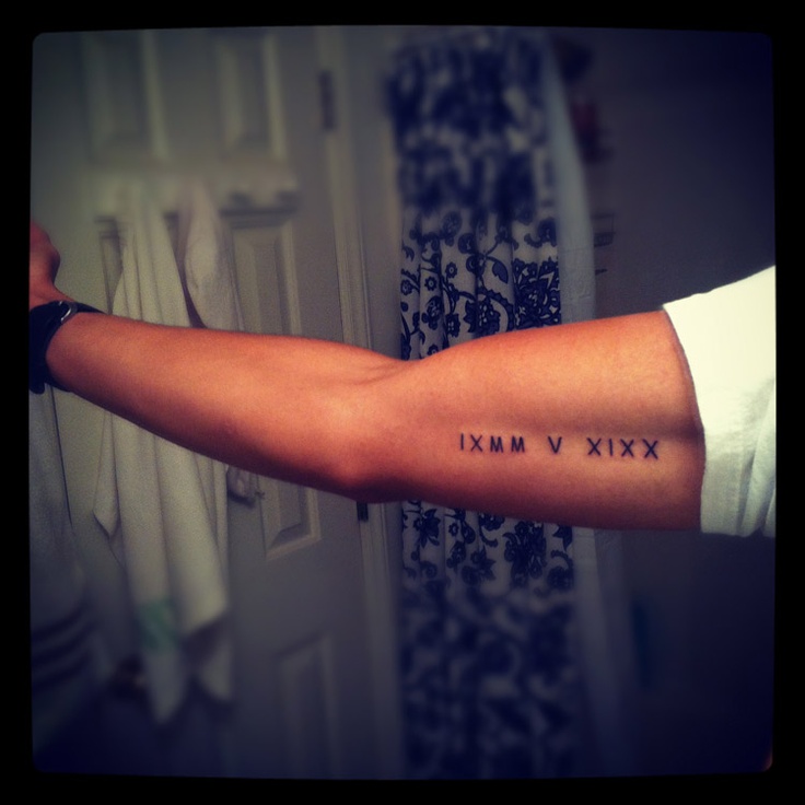 Black romania number tattoo on arm