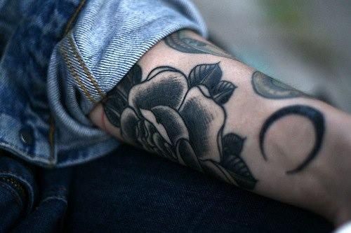 Black rose and moon tattoo on arm