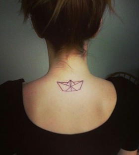 Black ship origami tattoo on shoulder