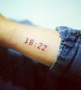 Black simple number tattoo on arm