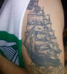 Black simple ship tattoo on arm