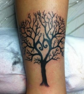 Black simple tree tattoo on leg