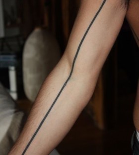 Black strong line tattoo on arm