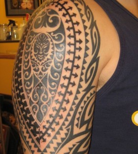 Black sun tribal tattoos on arm
