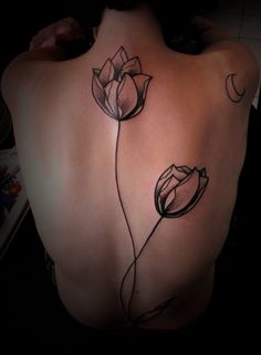 Black tulip tattoo on back