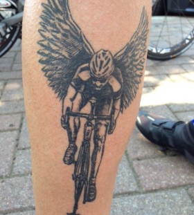 Black wings and bicycle tattoo on leg
