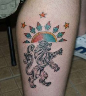 Black wolf and sun tattoo on leg
