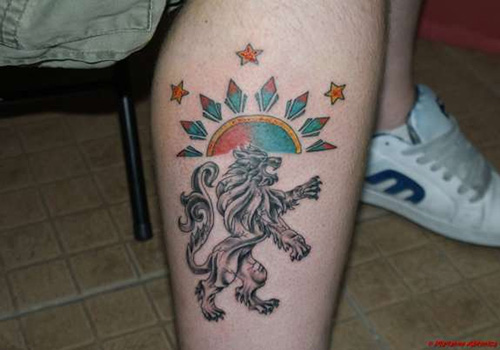 Black wolf and sun tattoo on leg