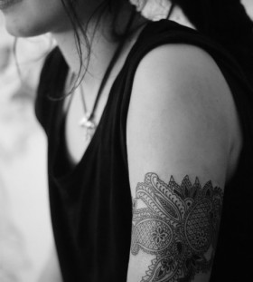 Black women's lace tattoo on arm