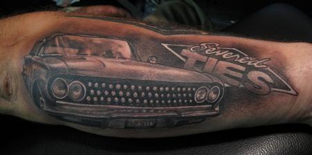 Black words and car tattoo on arm