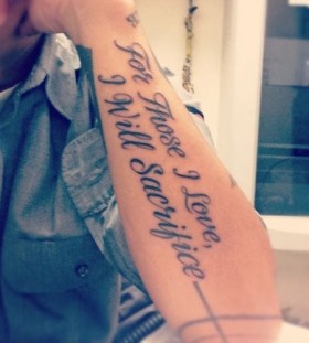 Black words quote tattoo on arm