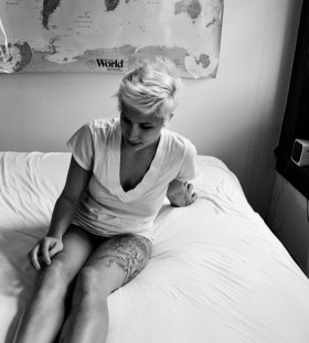 Blonde girl's map tattoo on legs