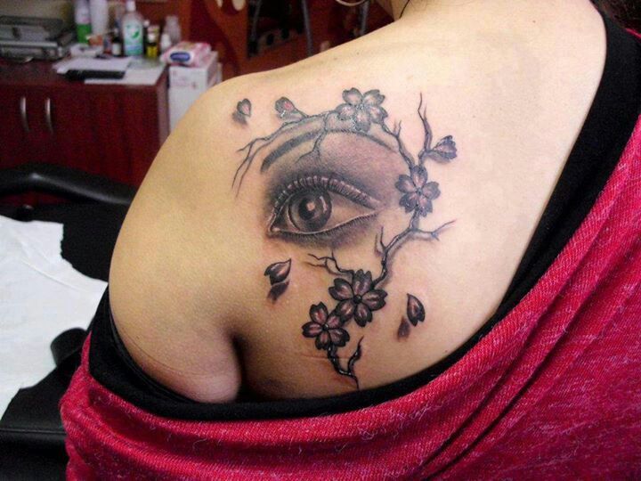 Blossom cherry eye tattoo on shoulder