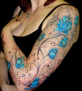 Blue and black flower tattoo on hand