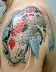 Blue and red fish tattoo on arm