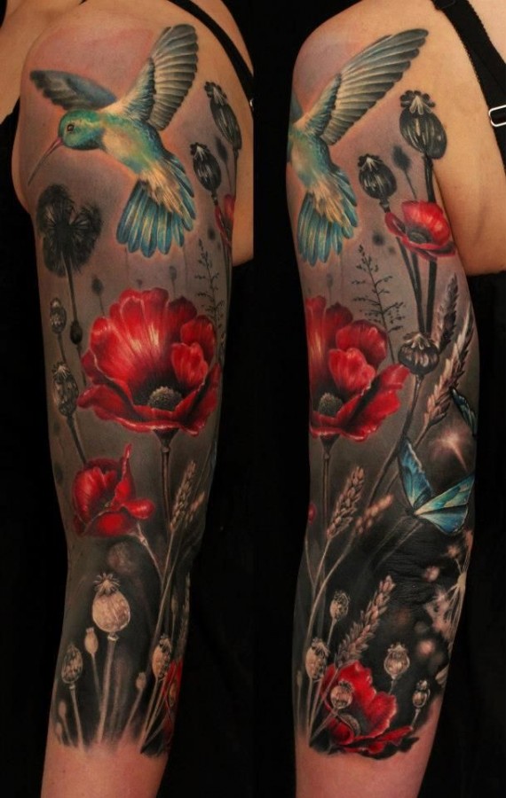 Blue bird and poppy tattoo on arm