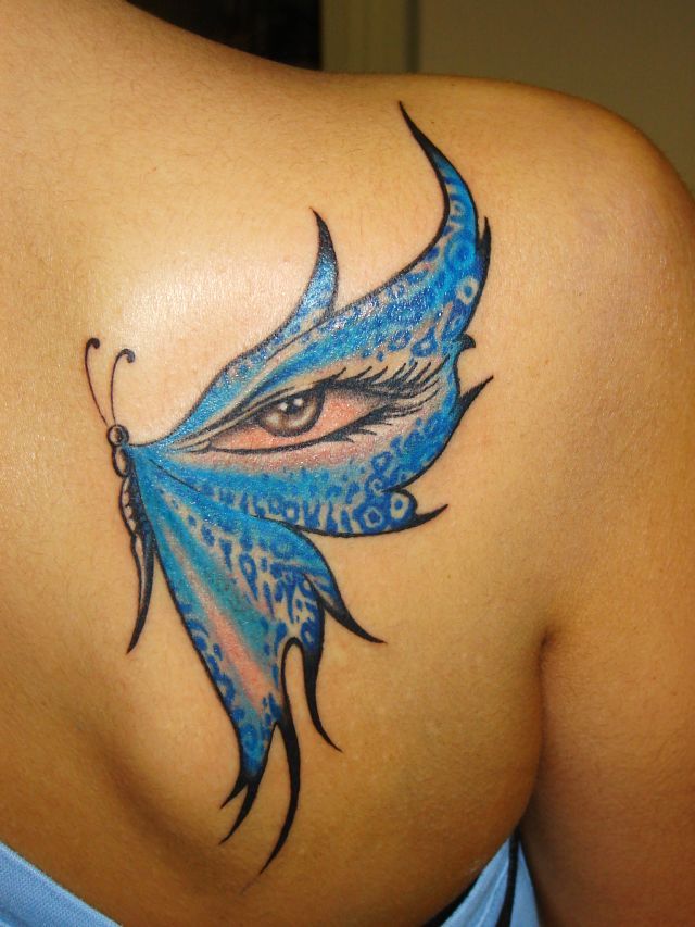 Blue butterfly and eye tattoo on shoulder