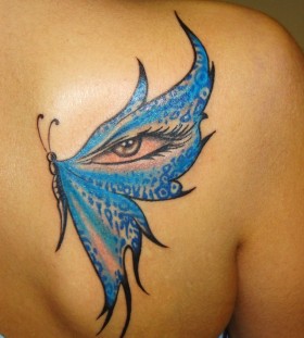 Blue eye and wing butterfly tattoo on shoulder