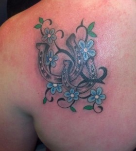 Blue flowers and horse shoe tattoo
