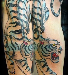 Blue funny tiger tattoo on arm