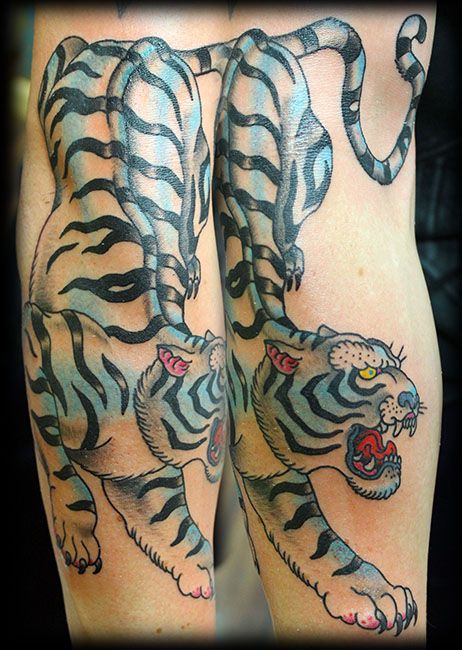 Blue funny tiger tattoo on arm